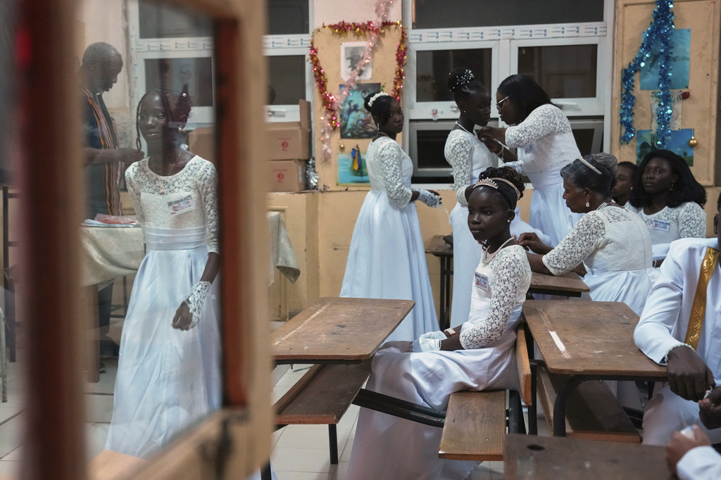 Worshippers who will receive the sacrament of baptism gather in a room ahead of the Easter Vigil Mass at Our Lady of the Angels Church in Dakar, Senegal, Saturday, April 4, 2026. (AP Photo/Misper Apawu)