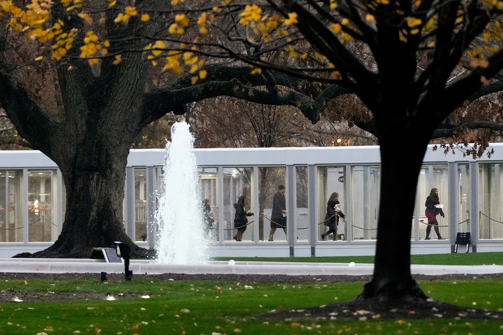 People walk through a newly constructed covered walkway on the North Lawn while arriving for a White House tour, Tuesday, Dec. 2, 2025, in Washington, as tours resume for the first time since construction of a new ballroom began at the White House. (AP Photo/Julia Demaree Nikhinson)