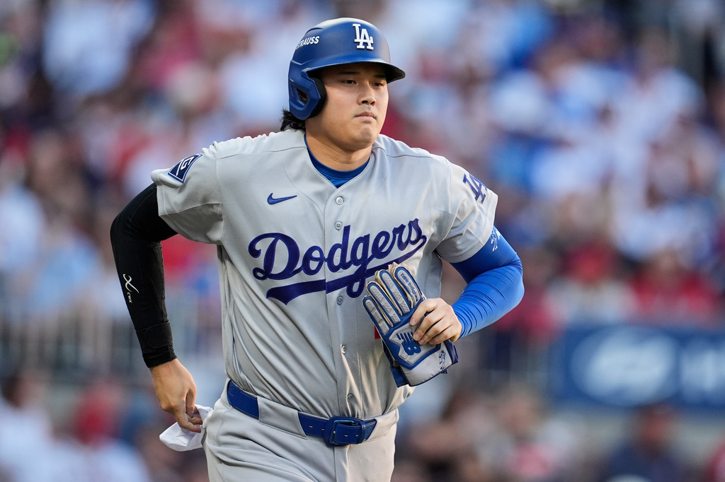 Los Angeles Dodgers two-way player Shohei Ohtani advances to first base on a walk during the second inning in Game 4 of baseball's National League Division Series against the Atlanta Braves, Wednesday, Oct. 7, 2026, in Atlanta. (AP Photo/Mike Stewart)