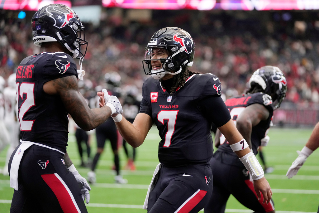 Houston Texans quarterback C.J. Stroud (7) smiles as he celebrates a touchdown catch against the Arizona Cardinals by Texans wide receiver Nico Collins, left, during the second half of an NFL football game Sunday, Dec. 14, 2025, in Houston. (AP Photo/Eric Christian Smith)