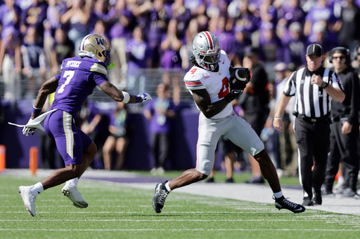 Ohio State wide receiver Jeremiah Smith (4) catches a pass with Washington cornerback Ephesians Prysock (7) defending during the first half of an NCAA college football game, Saturday, Sept. 27, 2025, in Seattle. (AP Photo/John Froschauer) Ohio State wide receiver Jeremiah Smith (4) catches a pass with Washington cornerback Ephesians Prysock (7) defending during the first half of an NCAA college football game, Saturday, Sept. 27, 2025, in Seattle. (AP Photo/John Froschauer)