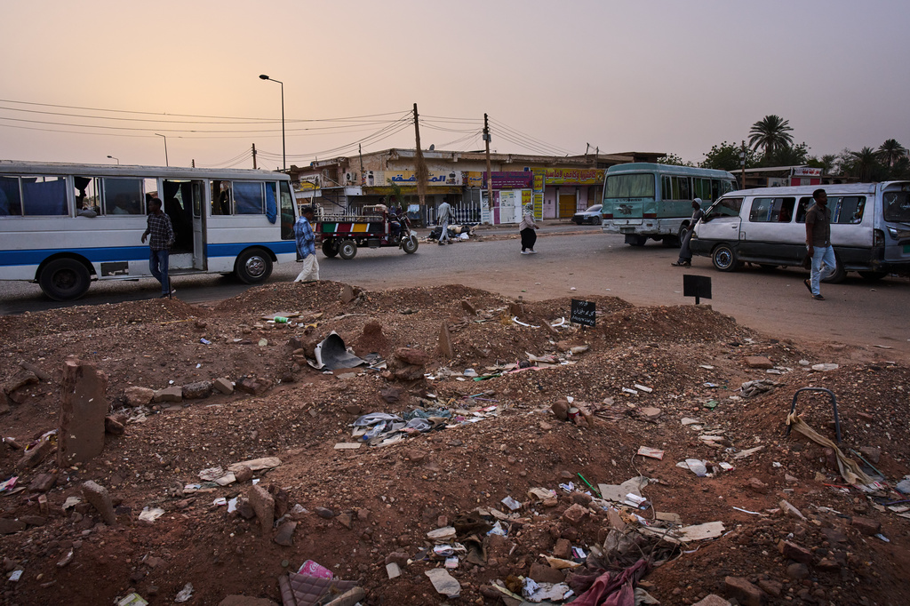 Graves that have overflowed onto the sidewalk of a street in Omdurman, on the outskirts of Khartoum, Sudan, Monday, April 20, 2026. (AP Photo/Bernat Armangue)