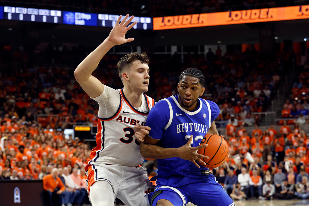 Kentucky forward Mouhamed Dioubate (23) drives to the basket as Auburn forward Filip Jovic (38) defends during the first half of an NCAA college basketball game Saturday, Feb. 21, 2026, in Auburn, Ala. (AP Photo/Butch Dill)