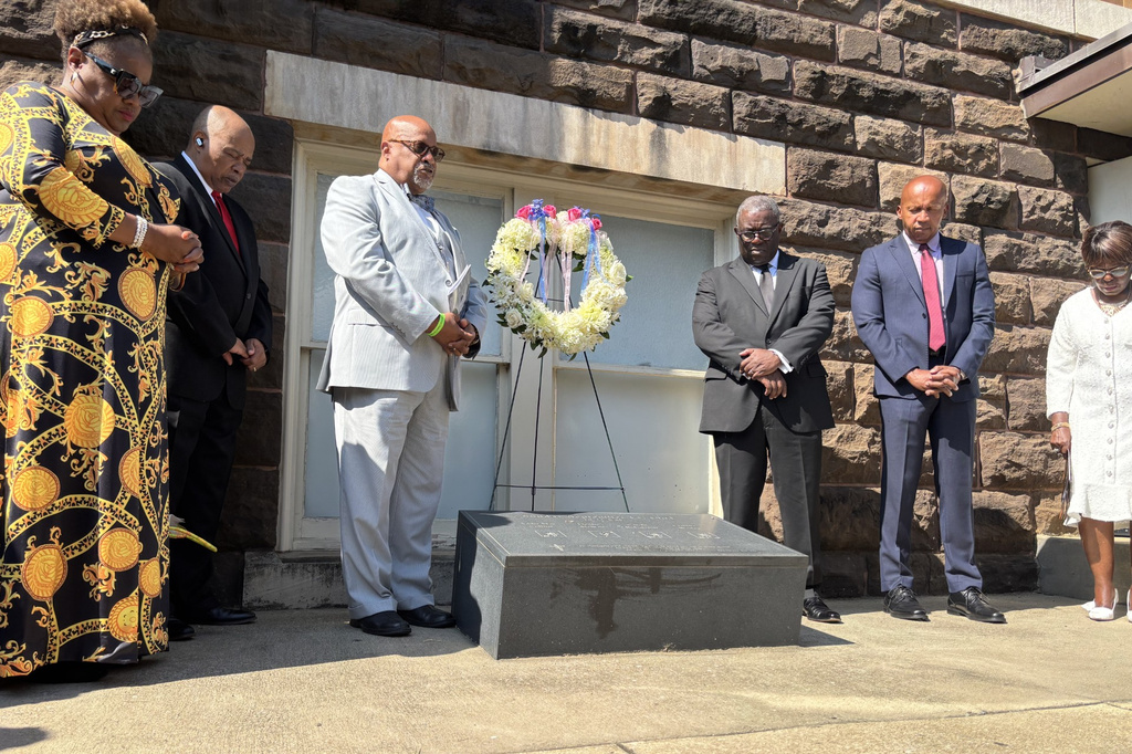 This photo taken with a smartphone shows members of the congregation and guests bowing their heads during a commemoration service in honor of the 63rd anniversary of the church's bombing at 16th Street Baptist Church in Birmingham, Ala., Tuesday, Sept. 15, 2026. (AP Photo/Kim Chandler)
