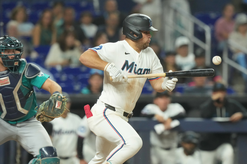 Miami Marlins' Jakob Marsee bunts the ball during the eighth inning of a baseball game against the Seattle Mariners Tuesday, July 7, 2026, in Miami. (AP Photo/Marta Lavandier)