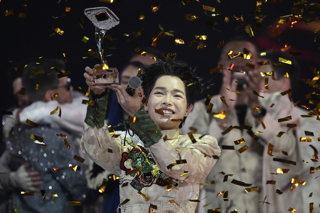 Vietnam's Duc Phuc celebrates with his trophy after winning the International Music Competition "Intervision" at the Live Arena outside Moscow, Russia, Sunday, Sept. 21, 2025. (AP Photo/Alexander Zemlianichenko)
