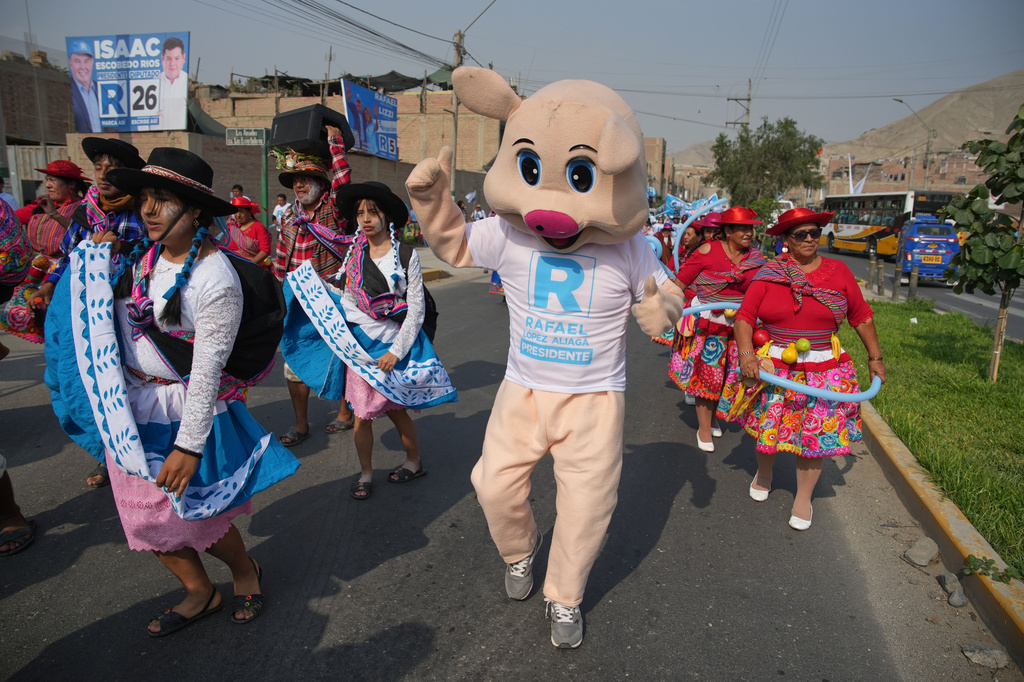 Supporters of presidential candidate Rafael López Aliaga, of the Popular Renewal party, dance as they arrive at a campaign rally in the Manchay neighborhood of Lima, Peru, Saturday, April 4, 2026. (AP Photo/Martin Mejia)