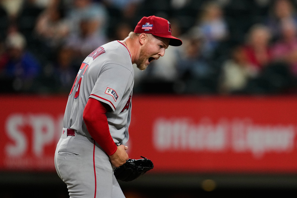 Los Angeles Angels pitcher Ryan Watson celebrates after striking out Texas Rangers' Evan Carter in the ninth inning of a baseball game Friday, Aug. 21, 2026, in Arlington, Texas. (AP Photo/Tony Gutierrez)