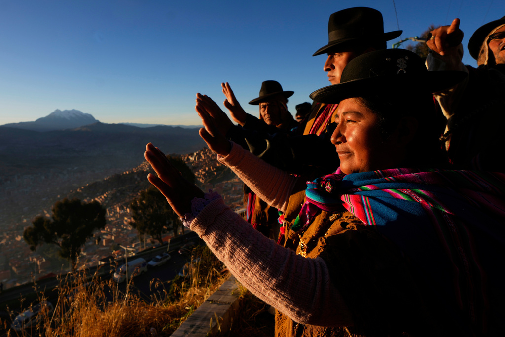 Aymara Indigenous people hold up their hands to receive the first rays of sunlight in celebration of the Andean New Year 5533, marking the Southern Hemisphere's winter solstice, in El Alto, Bolivia, June 21, 2025. (AP Photo/Juan Karita, File)