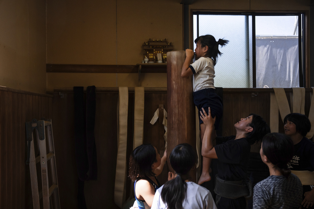 Wrestlers train during a practice session at a sumo camp in Tottori Johoku High School in Tottori, Japan, on July 29, 2025. (AP Photo/Louise Delmotte)