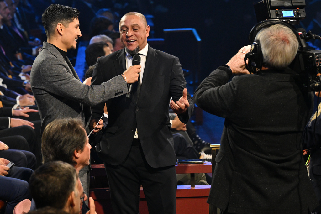 Former Brazil star Roberto Carlos is interviewed by actor Danny Ramirez during the draw for the 2026 soccer World Cup at the Kennedy Center in Washington, Friday, Dec. 5, 2025. (Mandel Ngan/Pool Photo via AP)