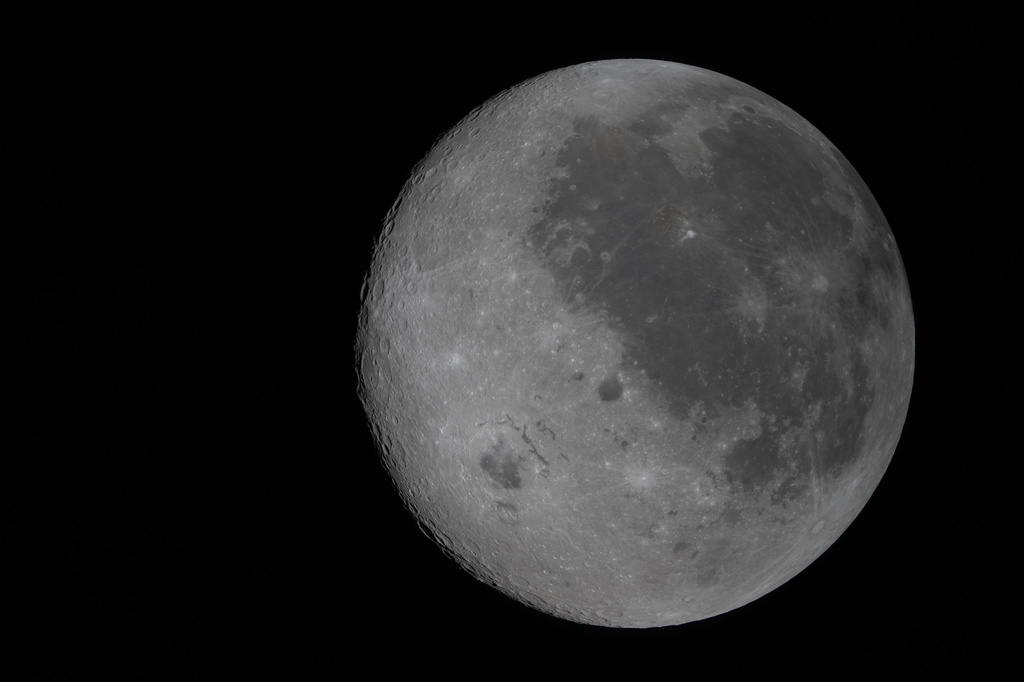 This image provided by NASA Monday, April 6, 2026, shows the Moon, the near side (the hemisphere we see from Earth) visible at the right side of the disk, identifiable by the dark splotches. At lower left is Orientale basin, a nearly 600-mile-wide crater that straddles the Moon’s near and far sides. Everything to the left of the crater is the far side. (NASA via AP)