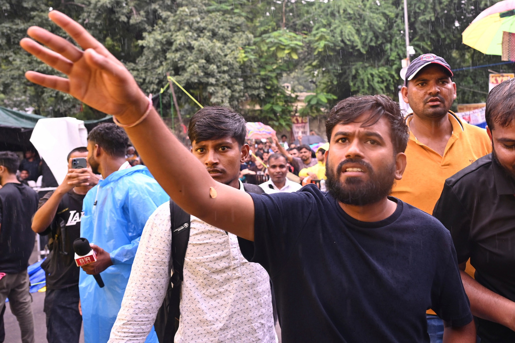 Abhijeet Dipke, founder of the Cockroach Janta Party, interacts with the protesters during a demonstration demanding educational reforms as part of the party's ongoing protest movement in New Delhi, India, Friday, July 24, 2026. (AP Photo/Vipin)
