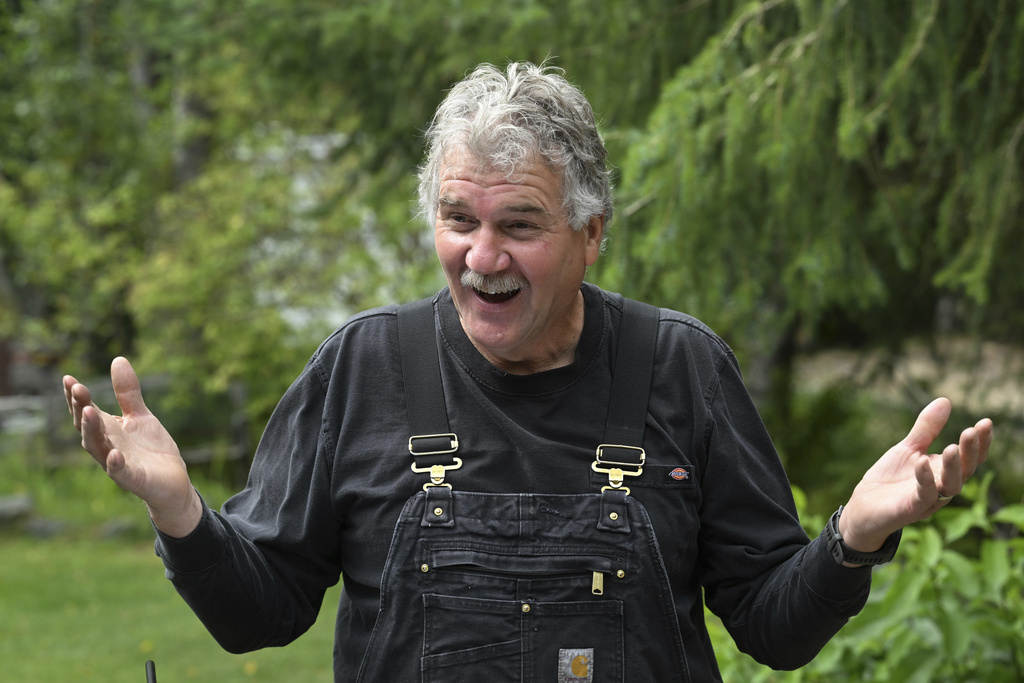 Mark Warren, an Alaska resident who received a new Ural motorcycle as a gift from the Russian government, gestures while speaking in Anchorage, Alaska, Monday, Aug. 18, 2025, after Russian President Vladimir Putin's visit to the state for a summit meeting with U.S. President Trump. (Bill Roth/Anchorage Daily News via AP)