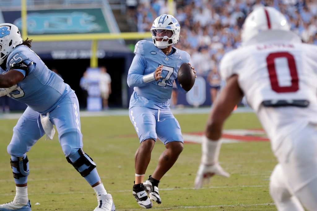 North Carolina quarterback Gio Lopez (7) looks to pass during the first half of an NCAA college football game against Stanford, Saturday, Nov. 8, 2025, in Chapel Hill, N.C. (AP Photo/Chris Seward)