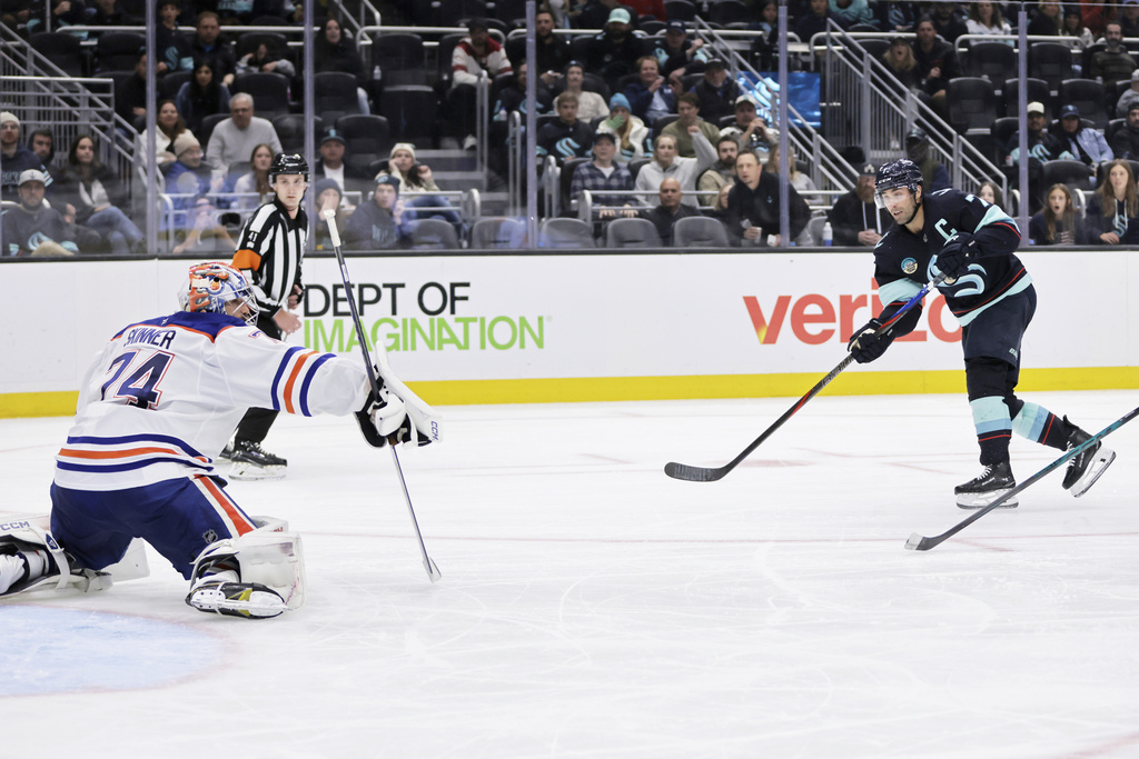Seattle Kraken right wing Jordan Eberle (7) scores against Edmonton Oilers goaltender Stuart Skinner (74) in the third period of an NHL hockey game Saturday, Oct. 25, 2025, in Seattle. (AP Photo/John Froschauer)