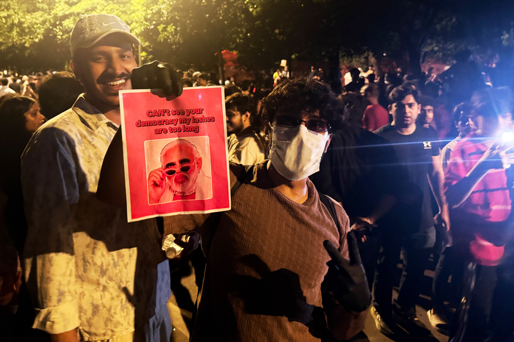 A protestor holds a placard with a portrait of Prime Minister Narendra Modi along with the text "Can't See Your Democracy, My Lashes are Too Long" during a demonstration demanding educational reforms as part of the Cockroach Janta Party's ongoing protest movement in New Delhi, India, Thursday, July 23, 2026. (AP Photo/Verda Subzwari)