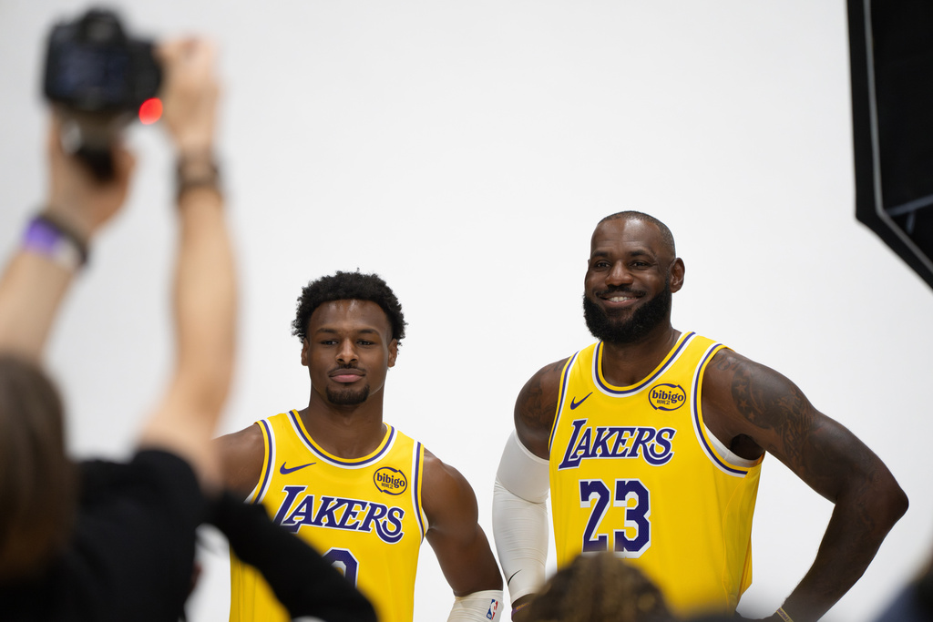 Los Angeles Lakers' LeBron James (23) and Bronny James (9) pose for photos during the NBA basketball team's media day in El Segundo, Calif., Monday, Sept. 29, 2025. (AP Photo/Jae C. Hong)