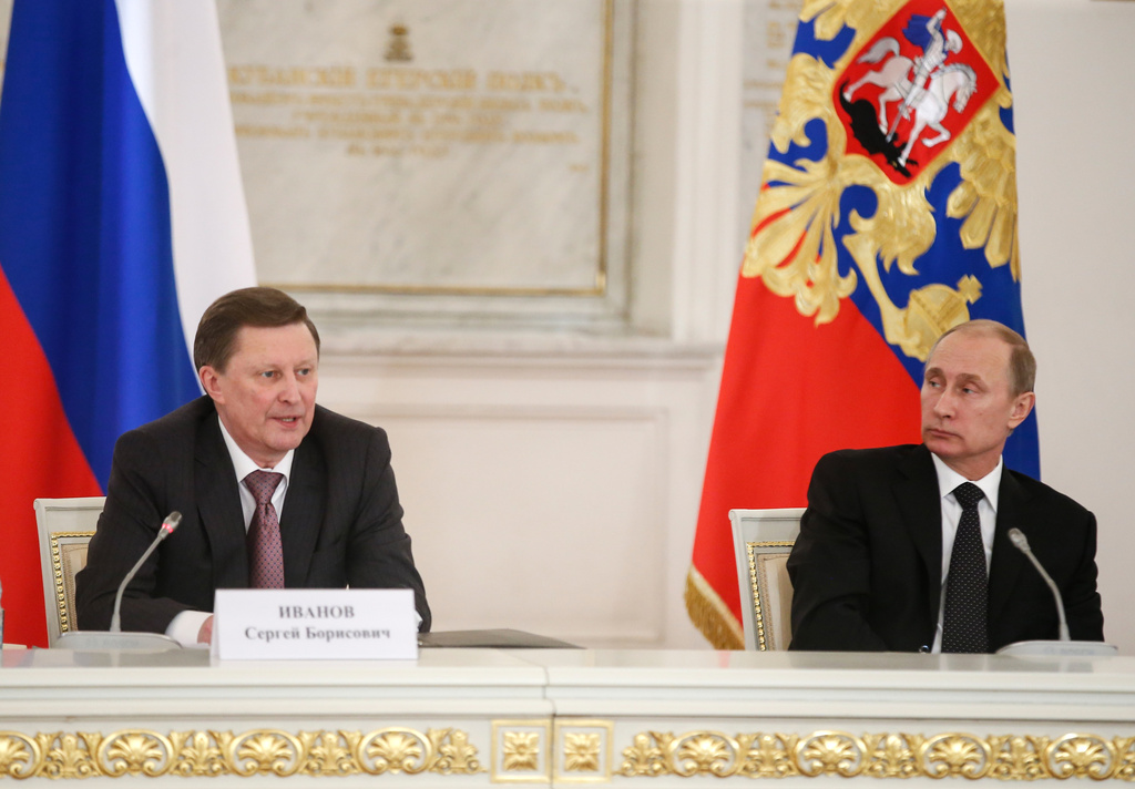 FILE - Russian President Vladimir Putin, right, and Kremlin's Chief of Staff Sergei Ivanov attend a meeting of the V-Day celebrations organizing committee in the Kremlin in Moscow, Russia, Tuesday, March 17, 2015. (AP Photo/Sergei Ilnitsky, Pool, File)