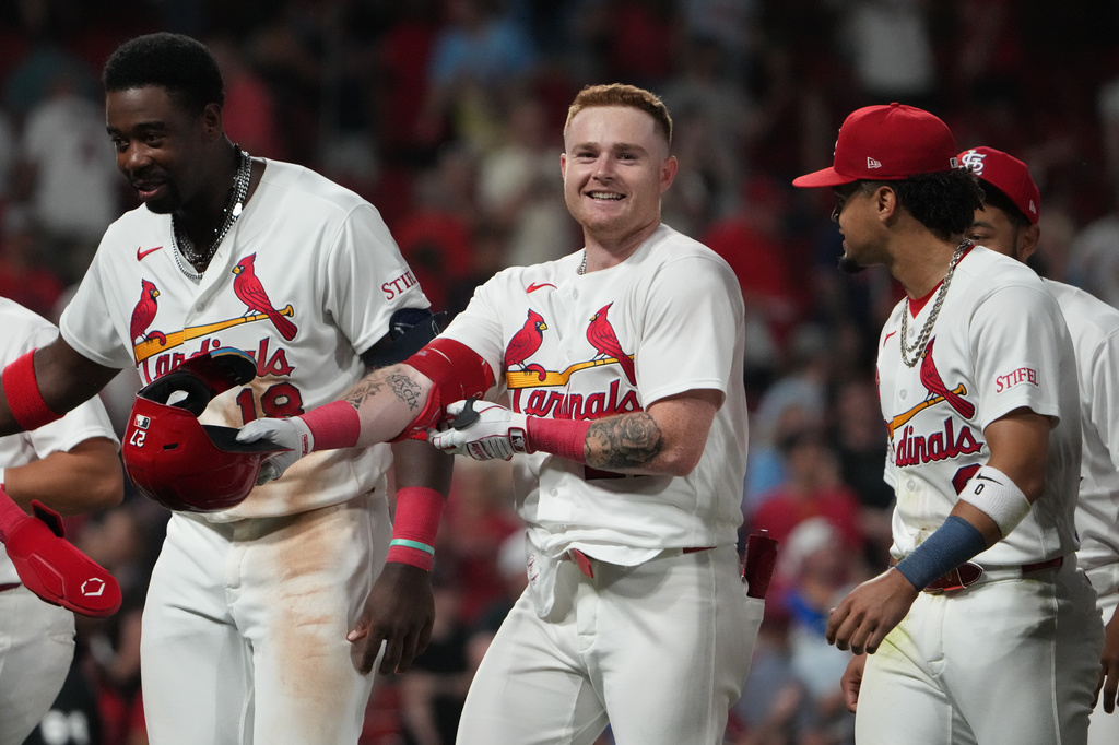 St. Louis Cardinals' Nathan Church, center, celebrates with teammates after hitting a sacrifice fly to score Thomas Saggese and defeat the Cleveland Guardians in a baseball game Tuesday, April 14, 2026, in St. Louis. (AP Photo/Jeff Roberson)
