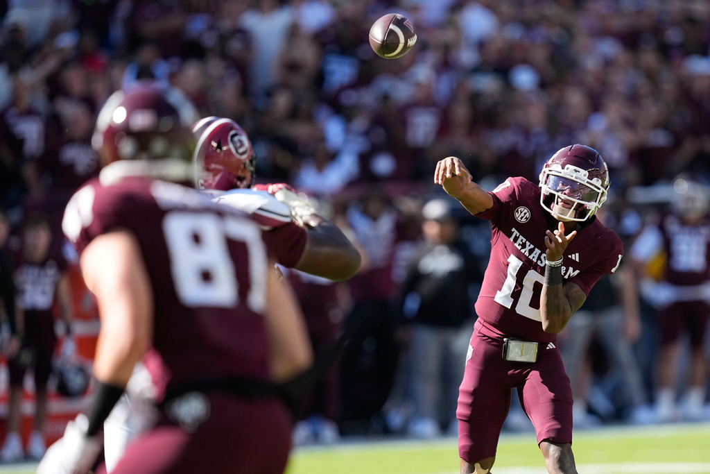 Texas A&amp;M quarterback Marcel Reed (10) throws a touchdown pass to tight end Nate Boerkircher (87) during the second half of an NCAA college football game against South Carolina Saturday, Nov. 15, 2025, in College Station, Texas. (AP Photo/David J. Phillip)