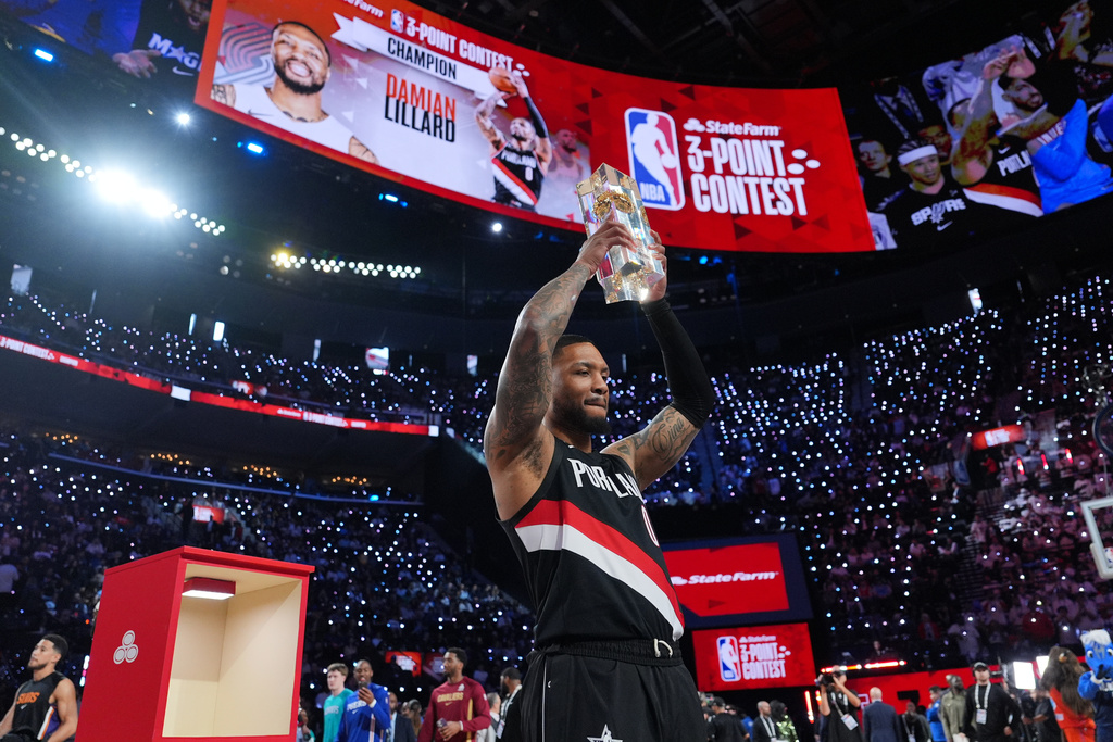 Portland Trailblazers guard Damian Lillard holds the winner's trophy after the 3-point contest at the NBA basketball All-Star weekend festivities Saturday, Feb. 14, 2026, in Inglewood, Calif. (AP Photo/Jae C. Hong)