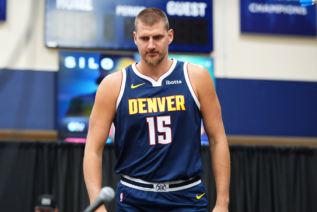Denver Nuggets center Nikola Jokić steps up to the podium to respond to questions from reporters during the NBA basketball team's media day Monday, Sept. 28, 2026, in Denver. (AP Photo/David Zalubowski)