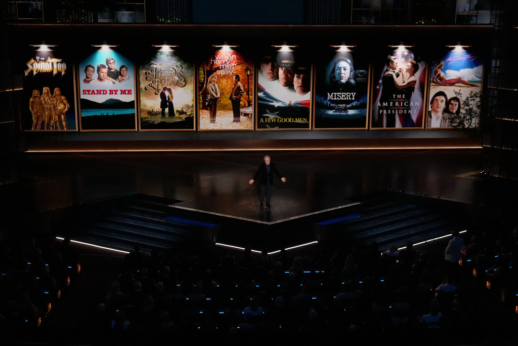 CORRECTS SPELLING OF MICHELE- Billy Crystal presents a tribute about Rob Reiner and Michele Singer Reiner during the Oscars on Sunday, March 15, 2026, at the Dolby Theatre in Los Angeles. (AP Photo/Chris Pizzello)