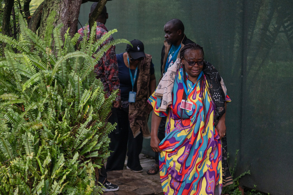 UNICEF staff members mourn at the home of their colleague who was killed in a drone strike in Goma, Democratic Republic of Congo, Wednesday, March 11, 2026. (AP Photo/Moses Sawasawa)