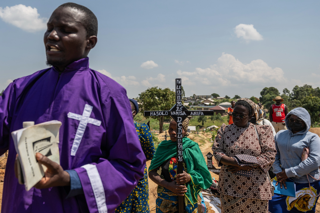 A Catholic priest takes part at the funeral of Vanisa Anifa, a 6-month-old orphaned girl who died of Ebola, in Bunia, Congo, Friday, June 19, 2026. (AP Photo/Moses Sawasawa)