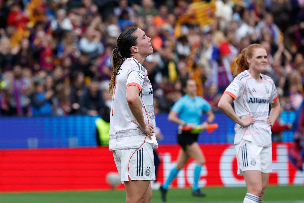 Bayern's Vanessa Gilles and Stine Ballisager, right, react at the end of the women's Champions League semifinal soccer match between FC Barcelona and FC Bayern Munich in Barcelona, Spain, Sunday, May 3, 2026. (AP Photo/Joan Monfort)