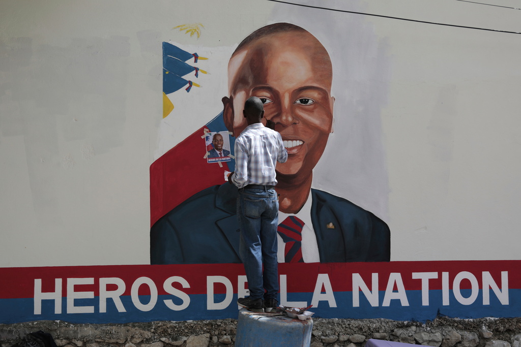 FILE - Artists paint a portrait of slain Haitian President Jovenel Moise near the presidencial residence where he was assassinated two years ago in the Petion-ville area of Port-au-Prince, Haiti, July 7, 2023. (AP Photo/Odelyn Joseph, File)