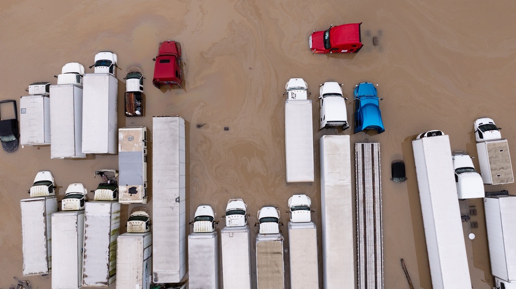 Flood water surrounds trucks from storms, in Kent, Wash., Tuesday, Dec. 16, 2025. (Erika Schultz/The Seattle Times via AP)