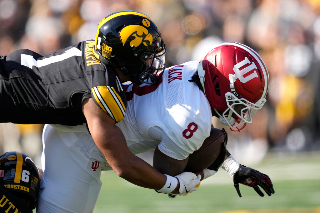 Indiana running back Kaelon Black (8) is tackled by Iowa defensive back Xavier Nwankpa (1) during the first half of an NCAA college football game, Saturday, Sept. 27, 2025, in Iowa City, Iowa. (AP Photo/Charlie Neibergall)