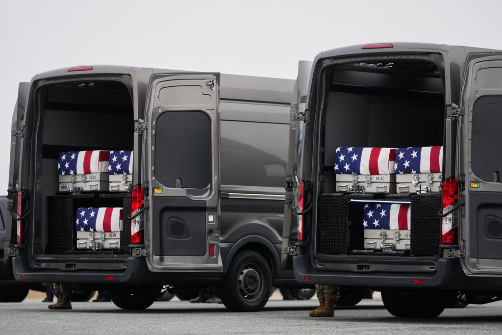 Transfer vans containing the remains of U.S. Army Reserve soldiers Maj. Jeffrey O'Brien, 45, of Indianola, Iowa, Capt. Cody Khork, 35, of Winter Haven, Florida, Chief Warrant Officer 3 Robert Marzan, 54, of Sacramento, Sgt. 1st Class Nicole Amor, 39, of White Bear Lake, Minnesot, Sgt. 1st Class Noah Tietjens, 42, of Bellevue, Nebraska and Sgt. Declan Coady, 20, of West Des Moines, Iowa, who were killed in a drone strike at a command center in Kuwait one day after the U.S. and Israel launched its military campaign against Iran, during a casualty return, Saturday, March 7, 2025, at Dover Air Force Base, Del. (AP Photo/Julia Demaree Nikhinson)