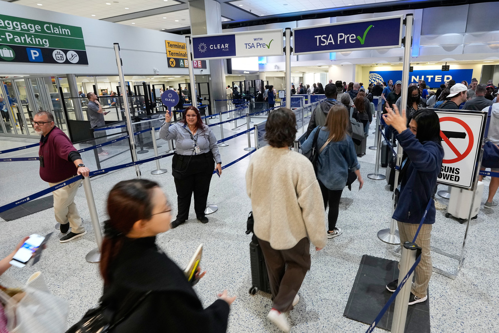 Passengers are directed through security checkpoint lines at George Bush Intercontinental Airport Thursday, March 19, 2026, in Houston. (AP Photo/David J. Phillip)