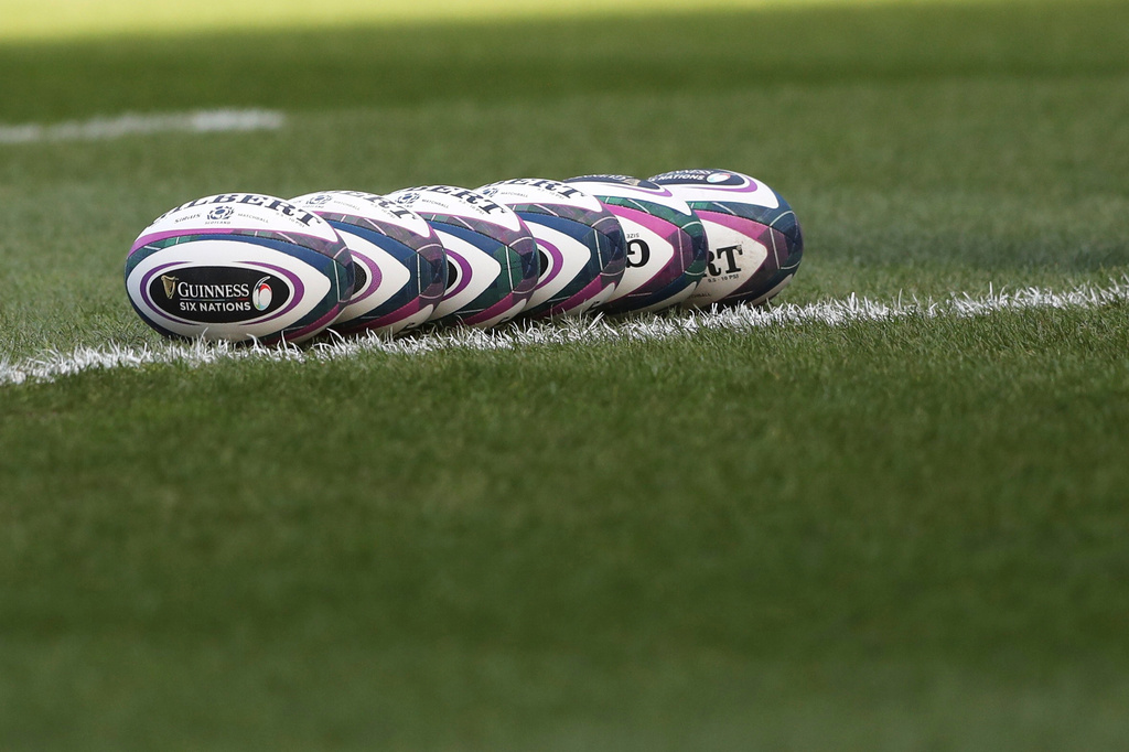 FILE - Rugby balls are lined up on the pitch prior to the start of the rugby union international match between Scotland and Italy in Edinburgh, Scotland, on March 20, 2021. (AP Photo/Scott Heppell, File)