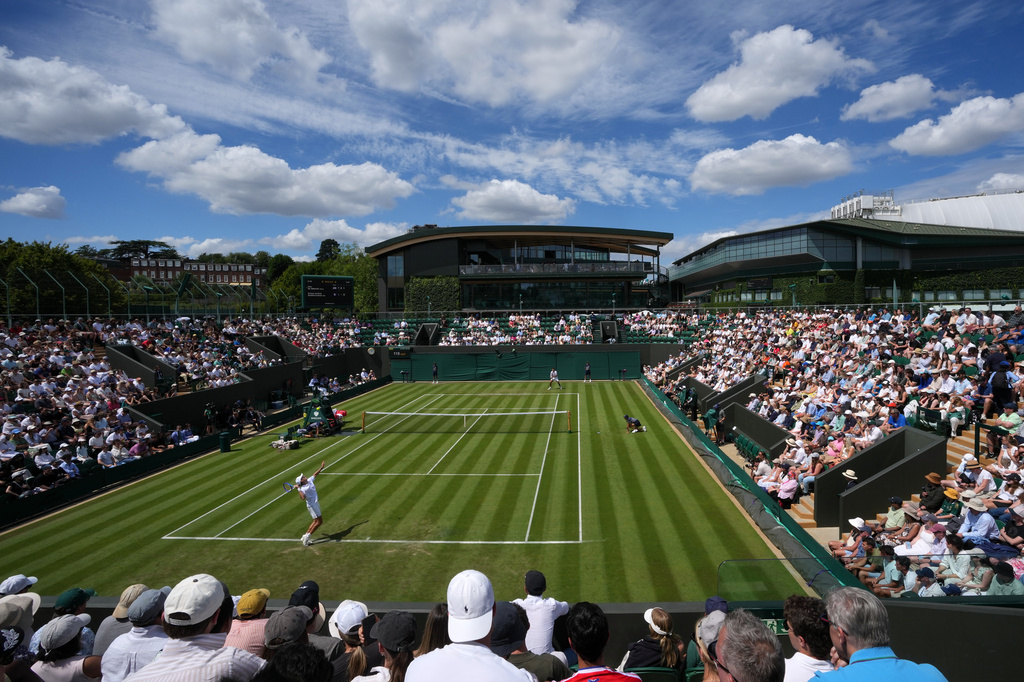 Tennis supporters watch the men's singles match Alex de Minaur of Australia against Roman Andres Burruchaga of Argentina at the Wimbledon Tennis Championships in London, Tuesday, June 30, 2026.(AP Photo/Kin Cheung)