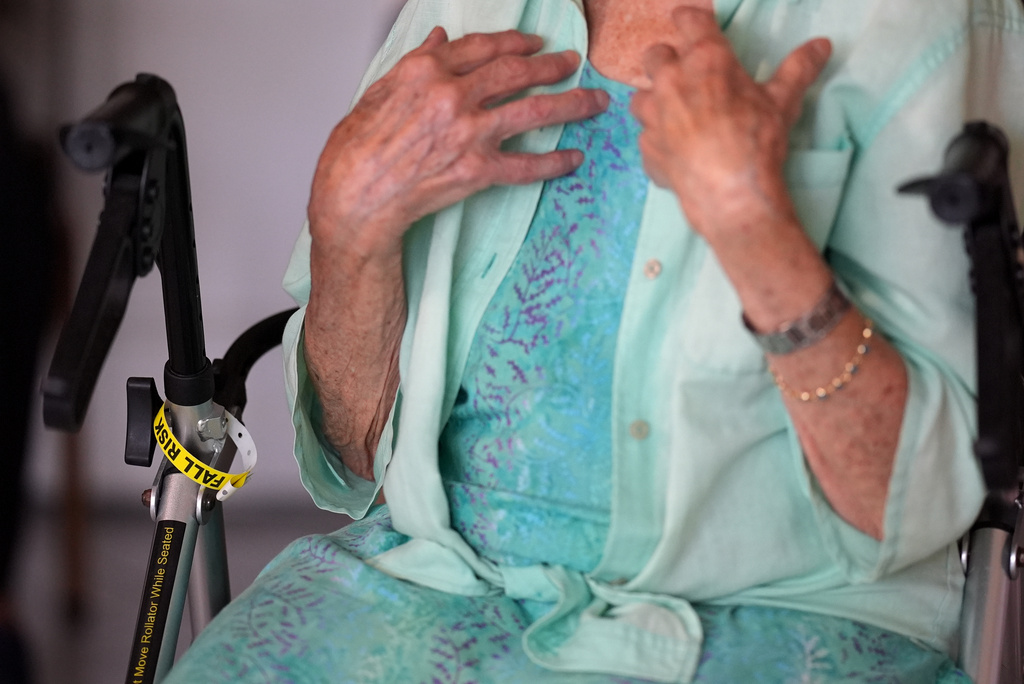 A "Fall Risk" alert bracelet marks the walker of Anna Fischbein as she speaks about the loss of a beloved Haitian home health care worker whose Temporary Protected Status expired this week, during an interview in her apartment, Thursday, July 30, 2026, in Sunny Isles Beach, Fla. (AP Photo/Rebecca Blackwell).