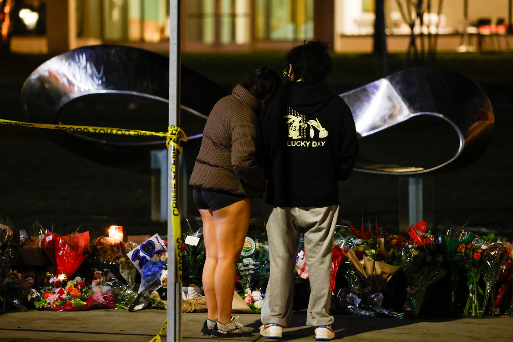 People visit a memorial outside of Brown University's Barus and Holley building in Providence, R.I., Wednesday, Dec. 17, 2025. (Lily Speredelozzi/The Sun Chronicle via AP)