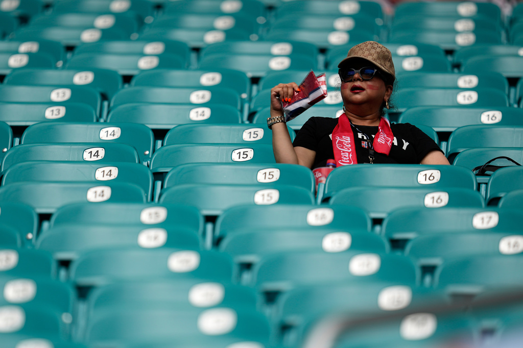 A spectator fan herself before the World Cup quarterfinal soccer match between Norway and England in Miami Gardens, Fla., Saturday, July 11, 2026. (AP Photo/George Walker IV)