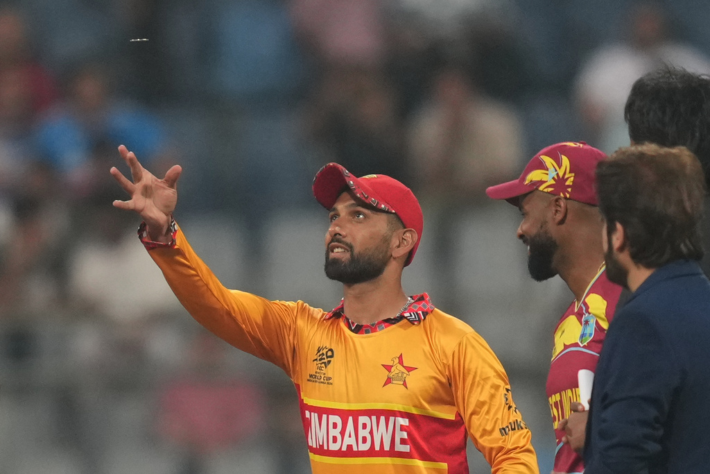 Zimbabwe's captain Sikandar Raza, left, toss the coin as West Indies' captain Shai Hope looks on before the start of the T20 World Cup cricket match between Zimbabwe and West Indies in Mumbai, India, Monday, Feb. 23, 2026. (AP Photo/Rafiq Maqbool)