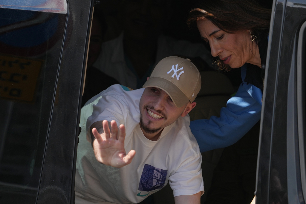 Freed Israeli hostage Eitan Mor gestures from a van as he arrives at Beilinson hospital in Petah Tikva, Israel, after he was released from Hamas captivity in the Gaza Stripl, Monday, Oct. 13, 2025. (AP Photo/Ariel Schalit)