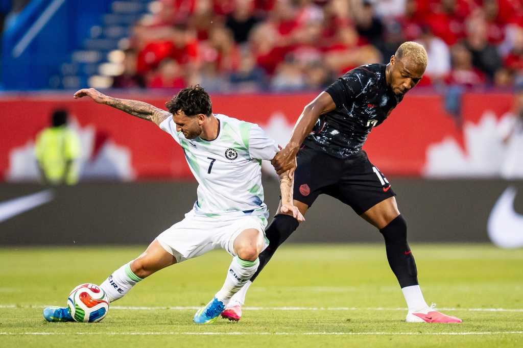 Canada's Derek Cornelius (13) and Republic of Ireland's Kevin O'Toole (7) vie for possession during first half of an International Friendly soccer match in Montreal, on Friday, June 5, 2026. (Christopher Katsarov/The Canadian Press via AP)