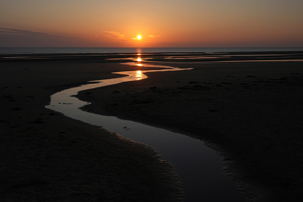 FILE - Sun rises over Omaha Beach near Colleville-sur-Mer Normandy, Thursday, June 6, 2024. (AP Photo/Laurent Cipriani, file)