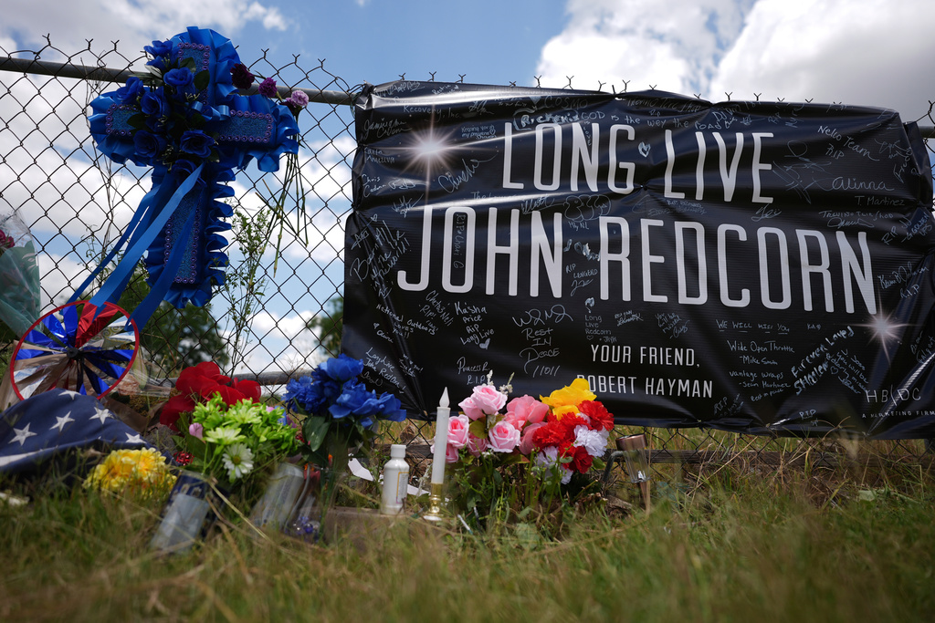 FILE - Candles, flowers, and notes are placed at a makeshift memorial in San Antonio, on Thursday, June 5, 2025, for voice actor Jonathan Joss who was recently killed. (AP Photo/Eric Gay, file)