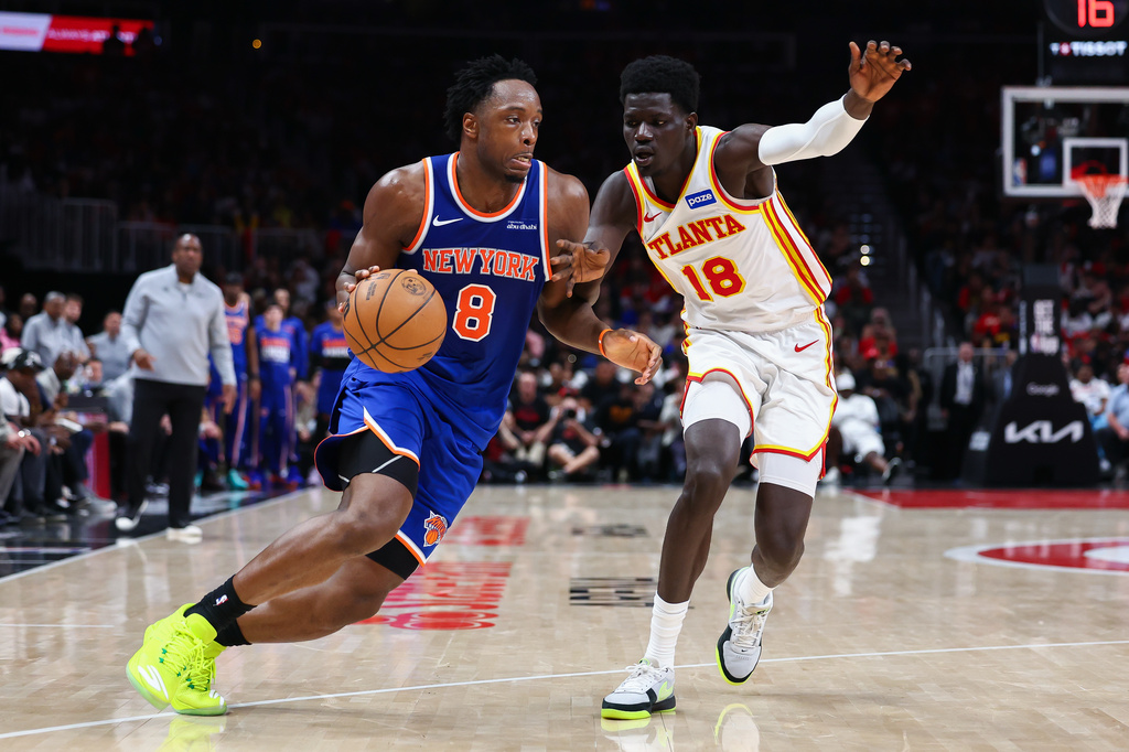 New York Knicks forward Og Anunoby (8) drives to the basket against Atlanta Hawks forward Mouhamed Gueye (18) during the second half in Game 3 of a first-round NBA playoffs basketball series, Thursday, April 23, 2026, in Atlanta. (AP Photo/Colin Hubbard)