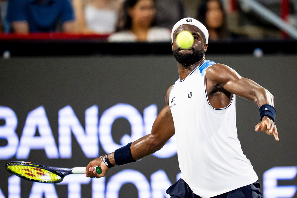 Frances Tiafoe, of the United States, returns a shot from Arthur Rinderknech, of France, during the National Bank Open tennis tournament in Montreal, Thursday, Aug. 6, 2026. (Christopher Katsarov/The Canadian Press via AP)