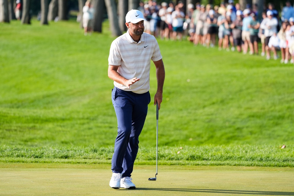 Scottie Scheffler reacts after his shot on the 12th green during the first round of the 3M Open golf tournament at the Tournament Players Club Thursday, July 23, 2026, in Blaine, Minn. (AP Photo/Bruce Kluckhohn)