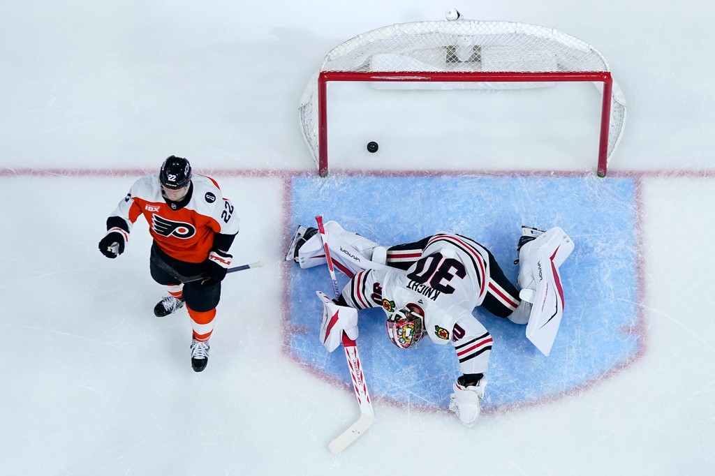 Philadelphia Flyers' Christian Dvorak, left, celebrates after scoring a goal against Chicago Blackhawks' Spencer Knight during the second period of an NHL hockey game Thursday, March 26, 2026, in Philadelphia. (AP Photo/Matt Slocum)